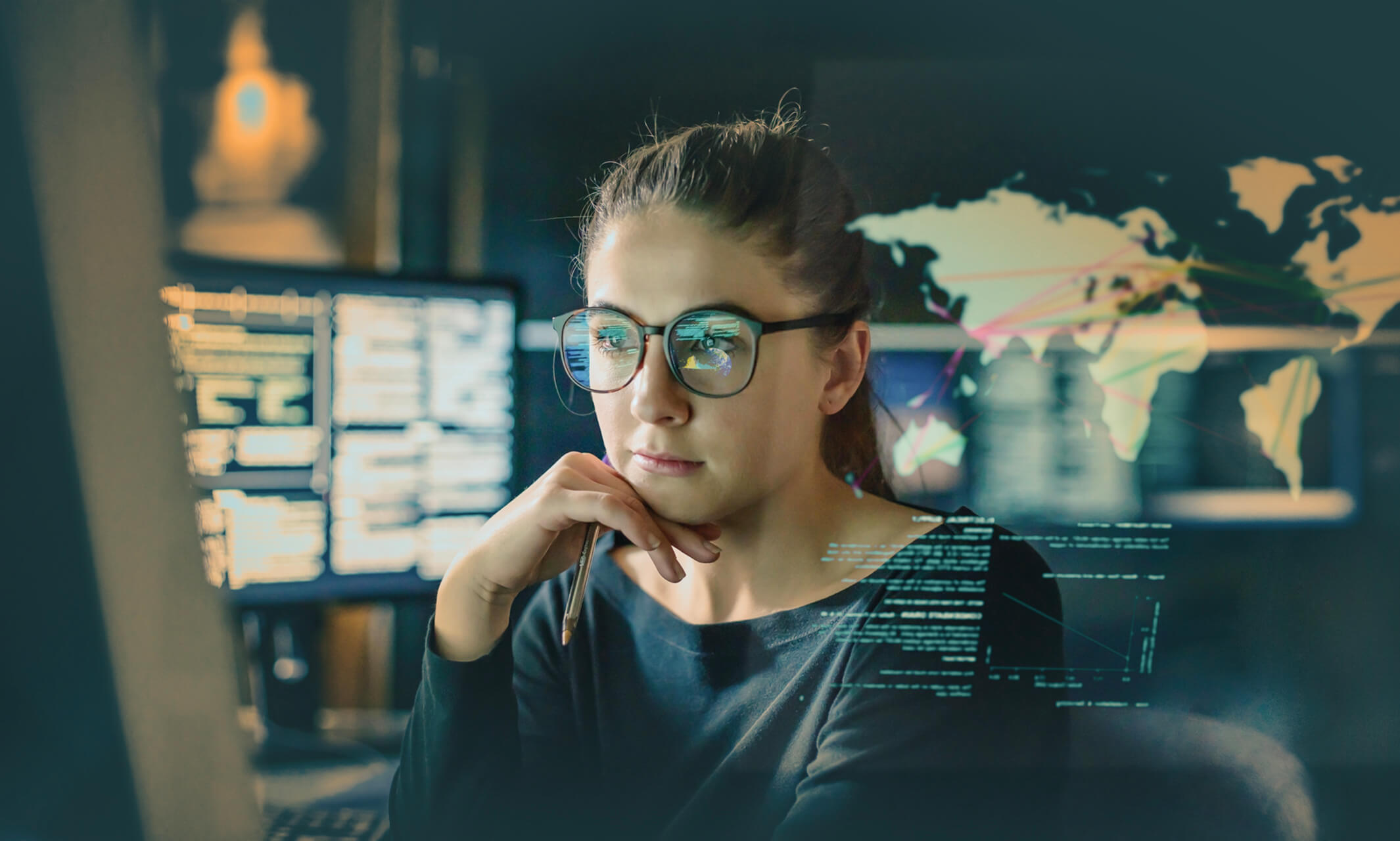 A woman with glasses studies data on a computer screen, with world maps and charts projected in a high-tech research