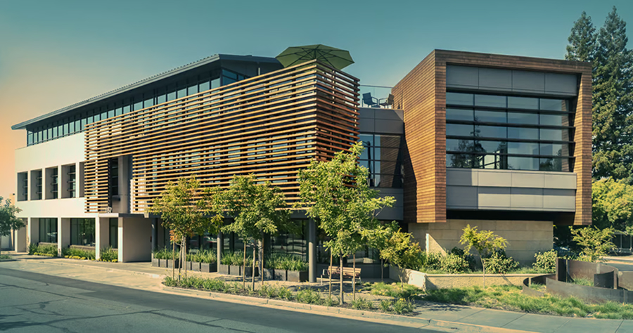 Modern multi-story office building with large glass windows, wooden accents, and surrounding greenery in Los Altos, CA.