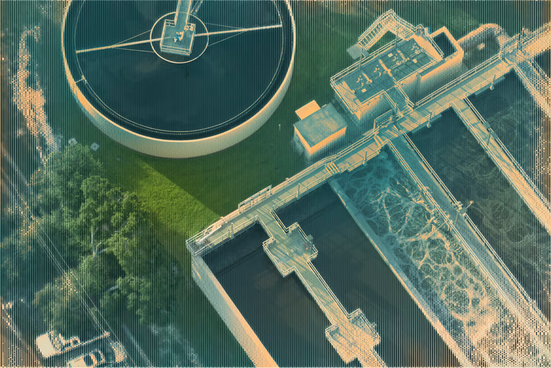 Aerial view of a water treatment plant with critical infrastructure, including tanks, pipes, and control buildings.
