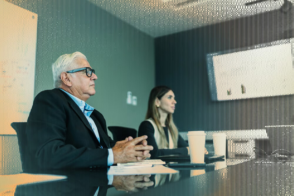 Censys Industries Financial Services Hero Two professionals sit at a conference table in a modern office, attentively listening during a financial services
