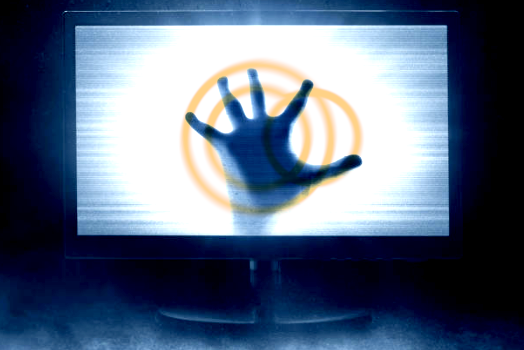 A hand pressed against a glowing screen with concentric circles radiating outward.